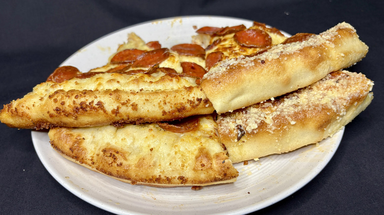 Four pieces of pizza stacked on plate