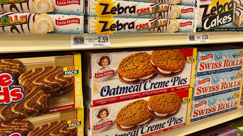 Grocery store shelves full of Little Debbie packaged snacks