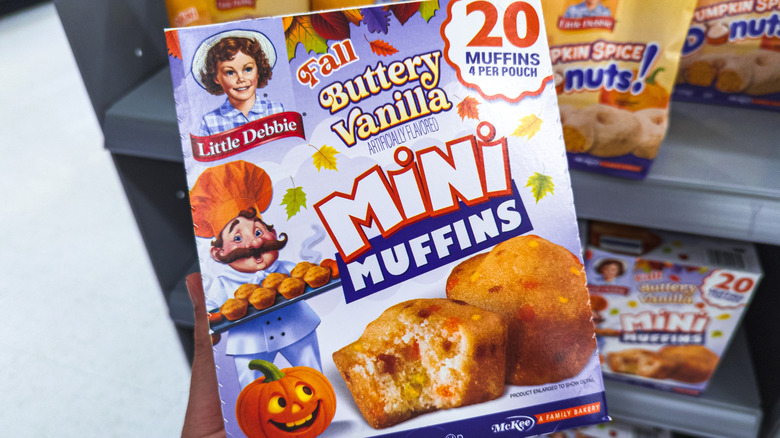 Hand holding a box of Little Debbie Fall mini muffins