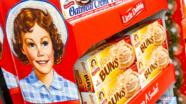 A cardboard rack of Little Debbie products with the logo and mascot on the side.