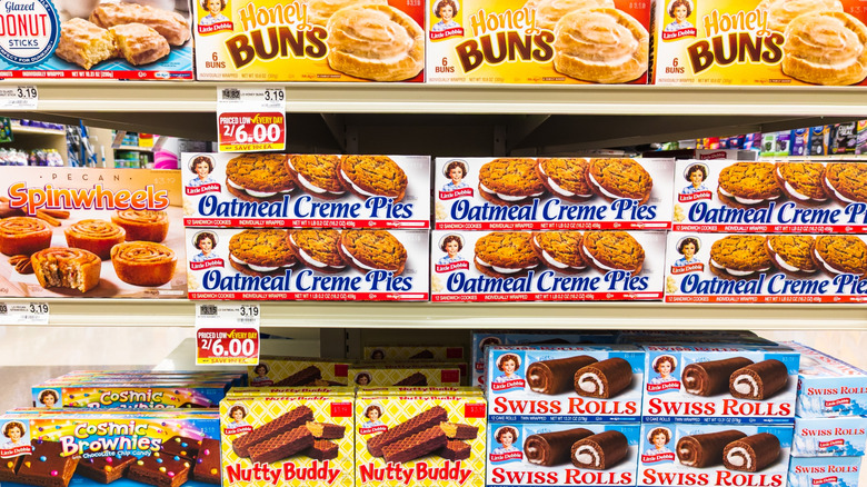 Various flavors of Little Debbie products on grocery store shelves.