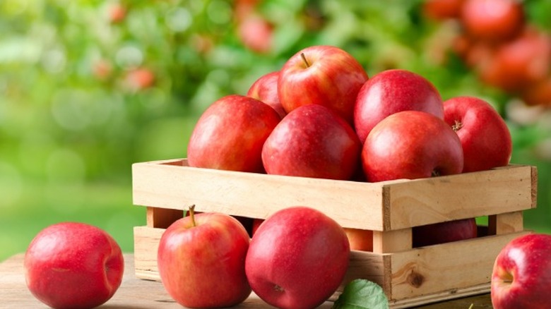 A wooden palette box of red apples