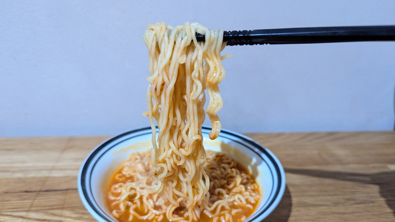 ramen noodles held by chopsticks