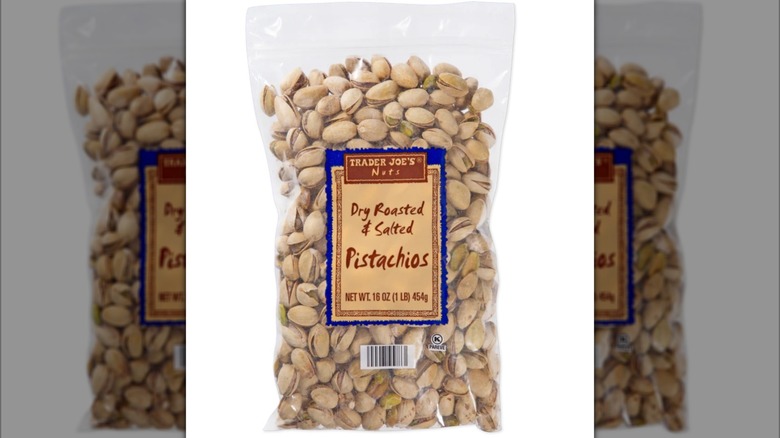 Trader Joe's Dry Roasted and Salted Pistachios in plastic bag on white background