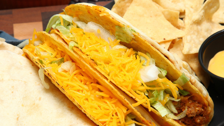 A Cheesy Gordita Crunch from Taco Bell, with chips in the background