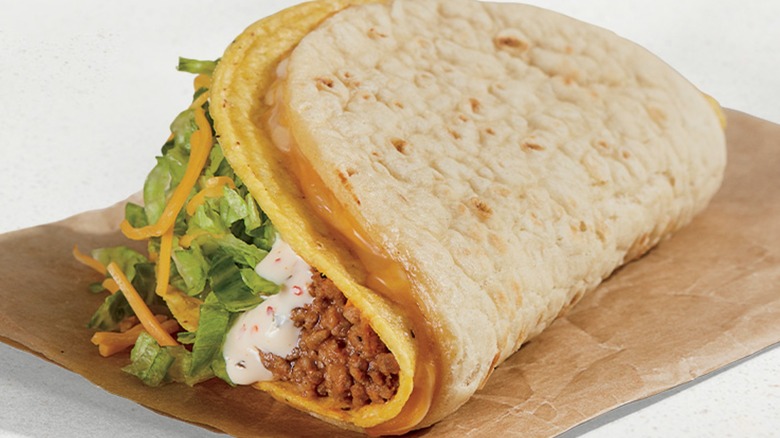 A Cheesy Gordita Crunch on a piece of brown paper wrap