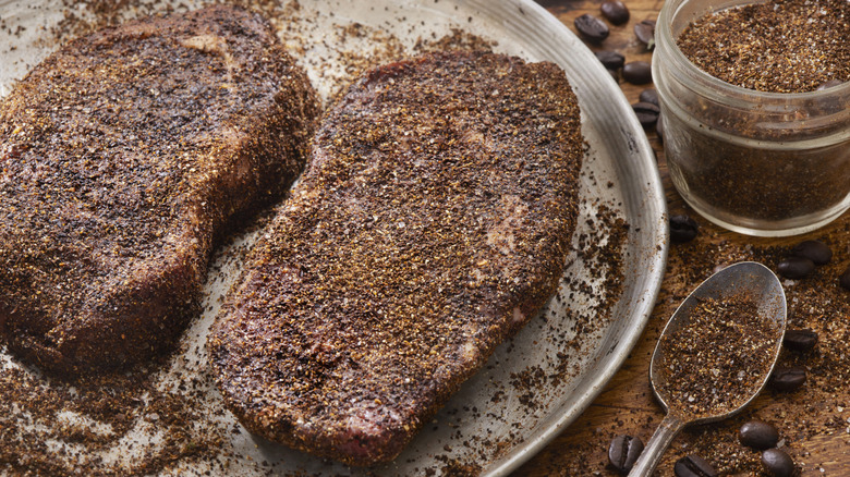 Raw steaks with coffee dry rub