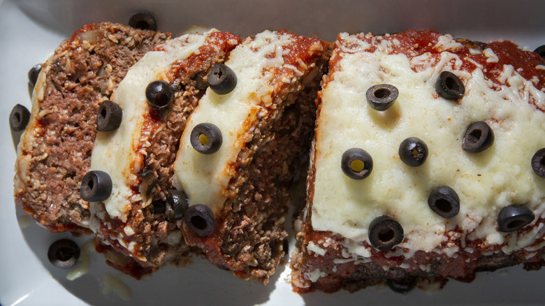 Italian meatloaf with sauce and cheese sliced up