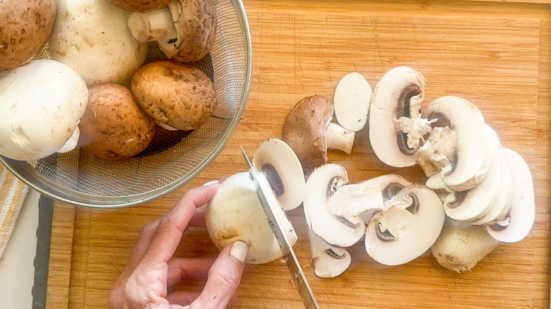 hand slicing mushrooms