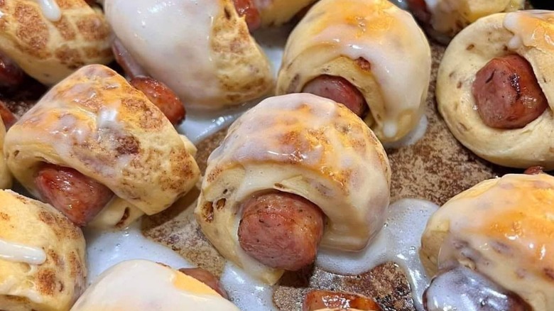 Pigs in a blanket made with cinnamon rolls drizzled with icing