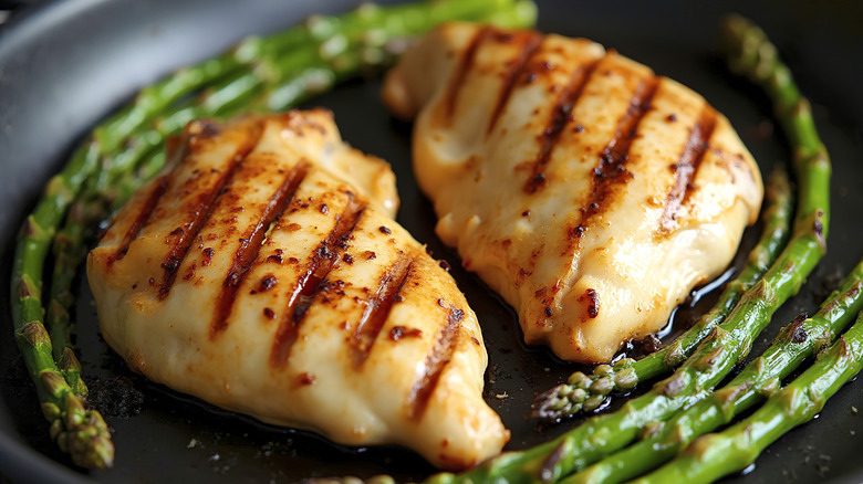 Grilled chicken breast served with asparagus