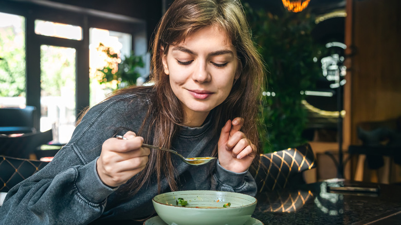 Woman eating soup
