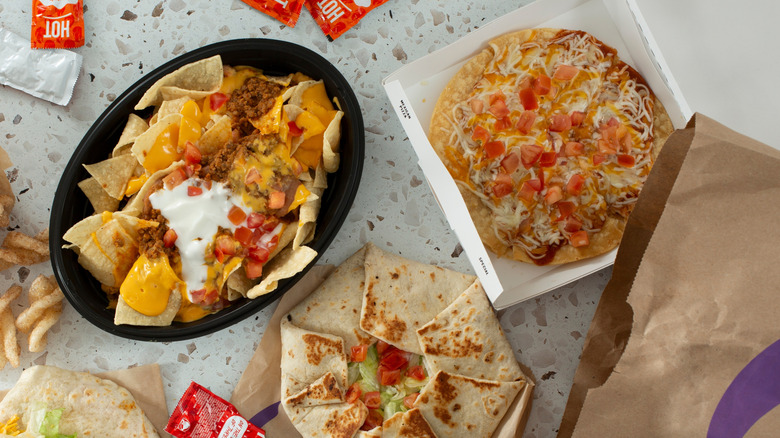 A variety of Taco Bell items including nachos, Crunch Wrap, and Mexican Pizza