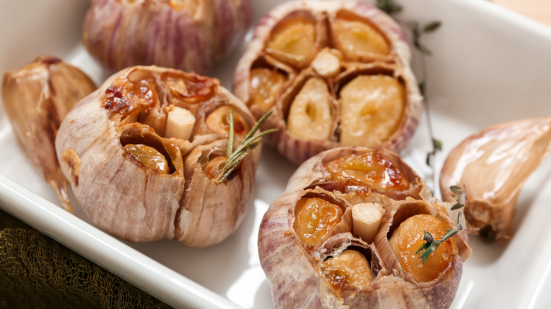 Roasted garlic with rosemary in a baking dish