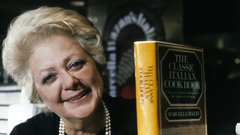 Marcella Hazan posing with her cookbook.
