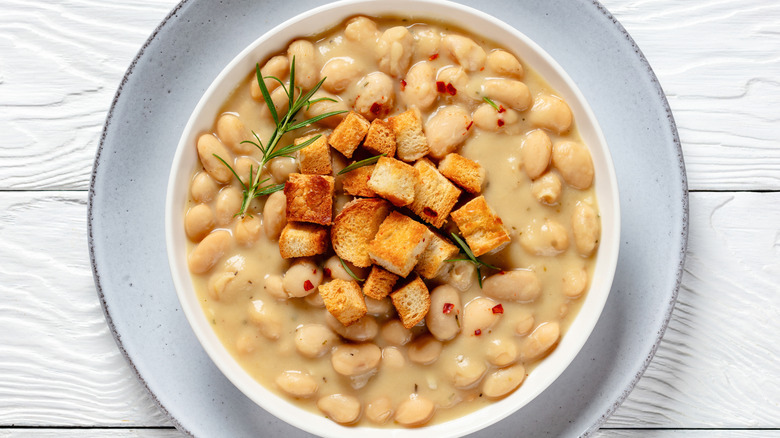 cannellini bean soup with croutons in a white bowl