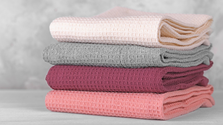 folded kitchen towels in pastel colors