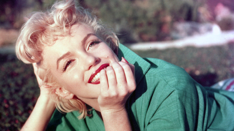 Marilyn Monroe smiling in a green top