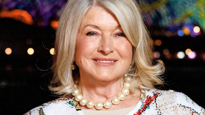 Martha Stewart smiles in a pearl necklace at an event