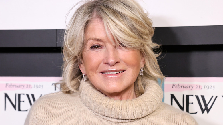 Martha Stewart smiles in a turtleneck sweater at an event