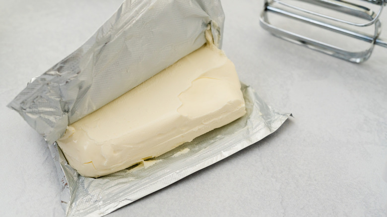 A block of cream cheese in foil wrapping