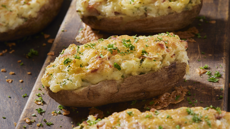 Twice baked potatoes stuffed with bacon bits and gouda cheese