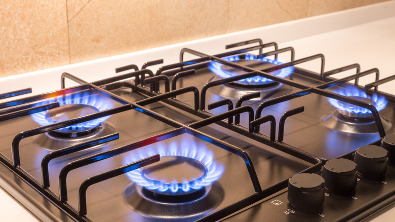 A gas stove, with all four burners lit