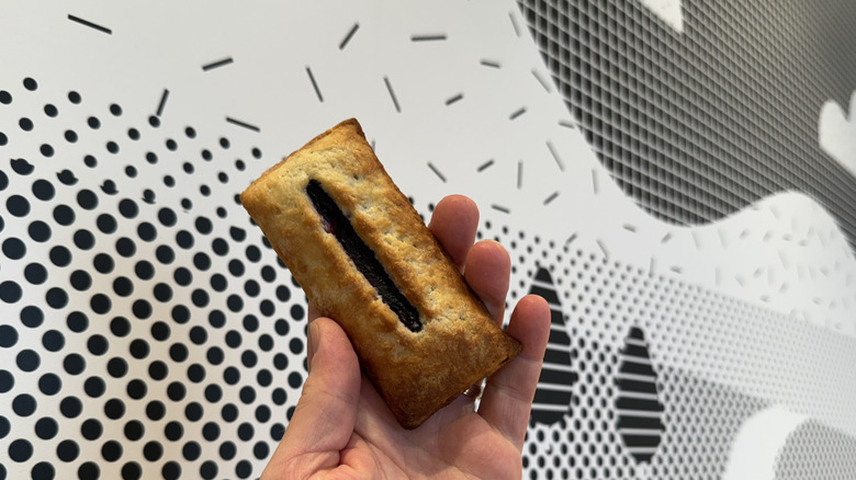 McDonald's Blueberry & Crème Pie Being held in the air