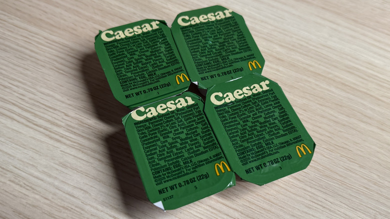 Four Caesar sauce cups in a square