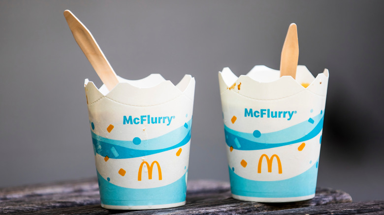 Two cups of McDonald's McFlurry treats with spoons inside