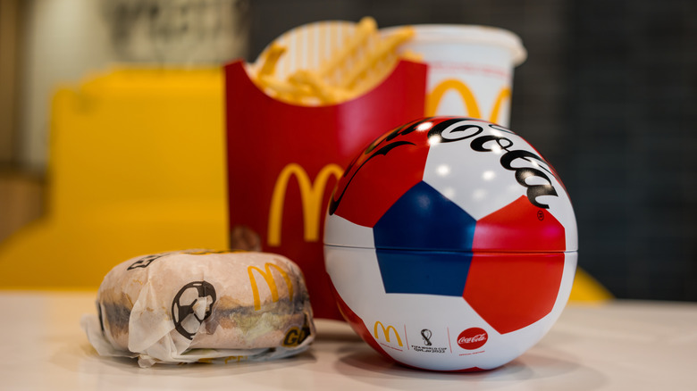 McDonald's food with a small soccer ball sitting nearby.