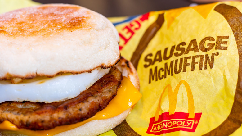 Sausage McMuffin with paper wrapper closeup.
