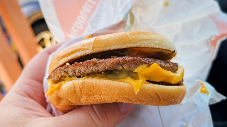 Person holding McDonald's McDouble burger