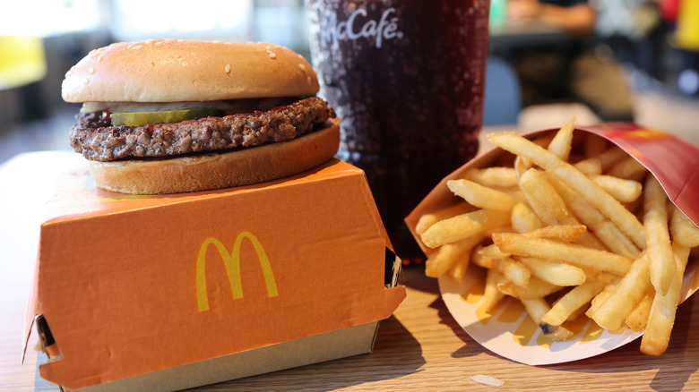 McDonald's burger on box, fries, and Coke