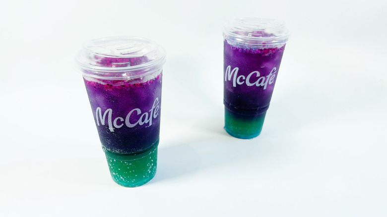 Two Red Bull Dragonberry Energizer drinks on a white background