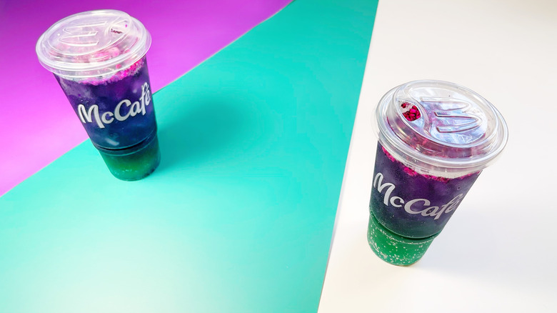 Two McDonald's Red Bull Dragonberry Energizers on a white, teal, and purple background