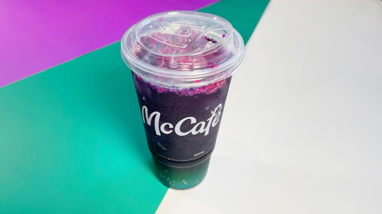 A Sugar-Free Red Bull Dragonberry Energizer on a white, teal, and purple background