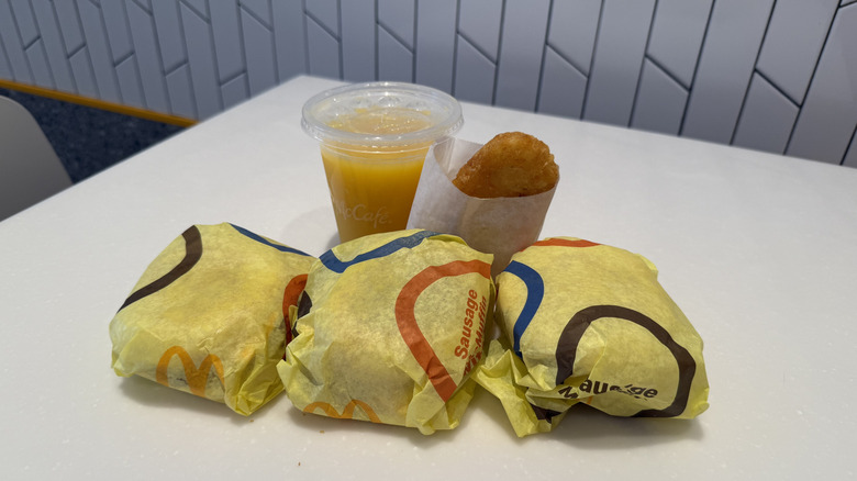 wrapped Spicy McMuffins, orange juice, and hash brown