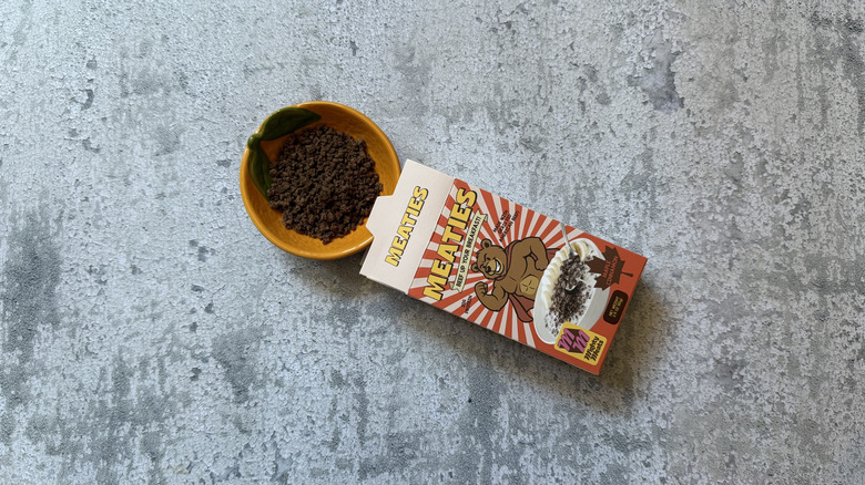 Maple Cinnamon Meaties Cereal package and poured into a yellow bowl