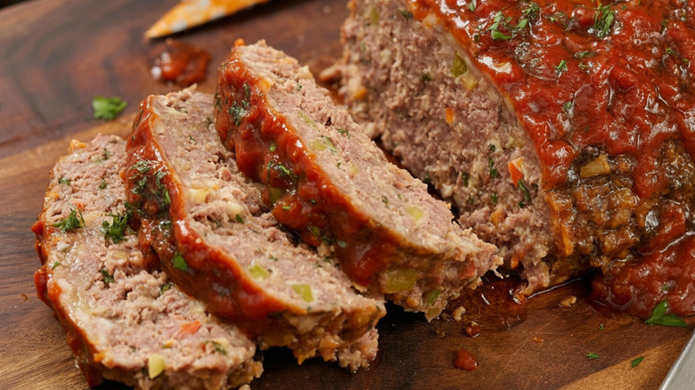 Sliced meatloaf on a wooden cutting surface