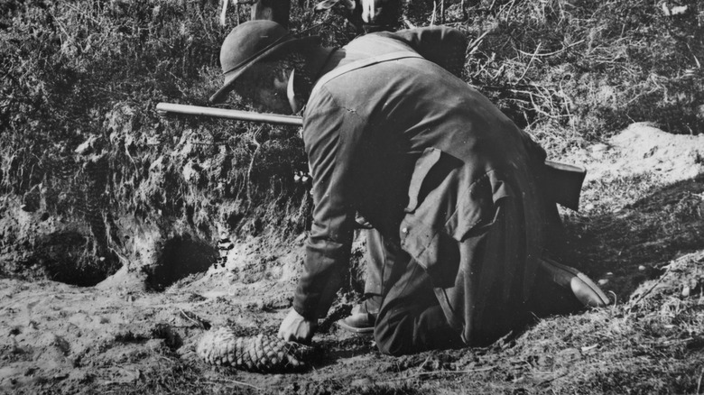 Old photo of gamekeepers collecting rabbits they hunted