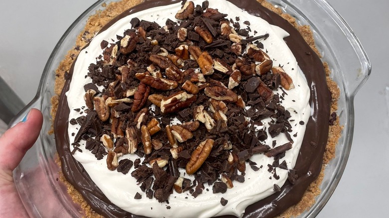 Person holding possum pie