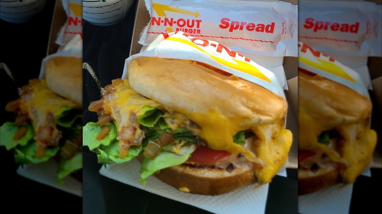 A grilled cheese sandwich from In-N-Out in a half-wrapper with In-N-Out spread beside it