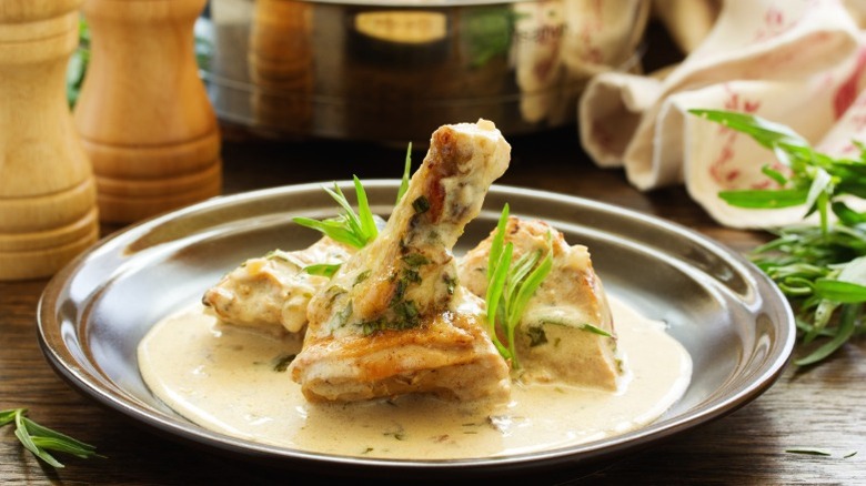 A serving of tarragon chicken on a plate.