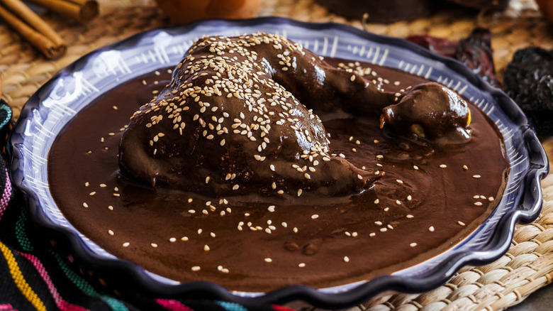 Chicken in mole poblano sauce with sesame seed garnish