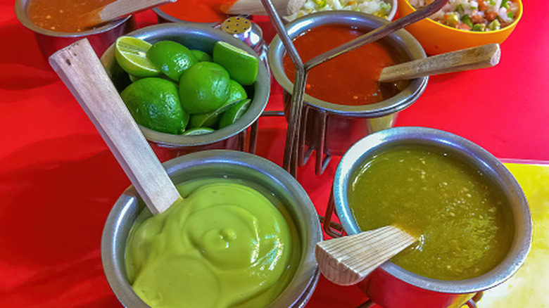 Assorted Mexican salsas and fresh limes