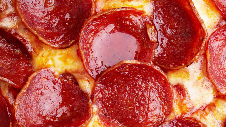 Close-up of pepperonis with grease pooled on top