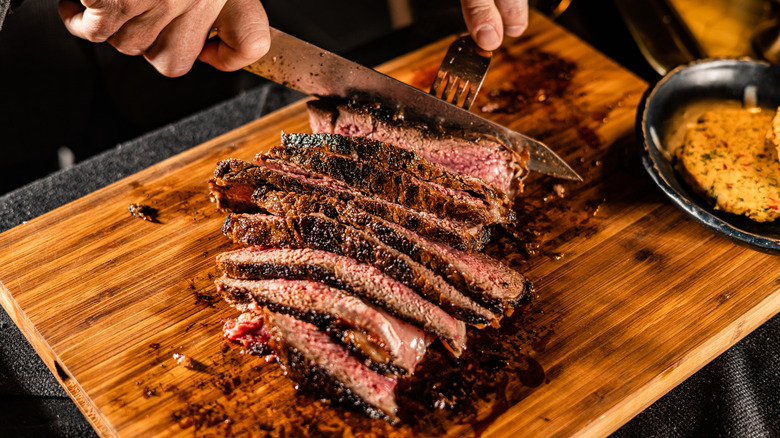 Cut and Served Table Side Tomahawk Steak inside intimate steakhouse restaurant