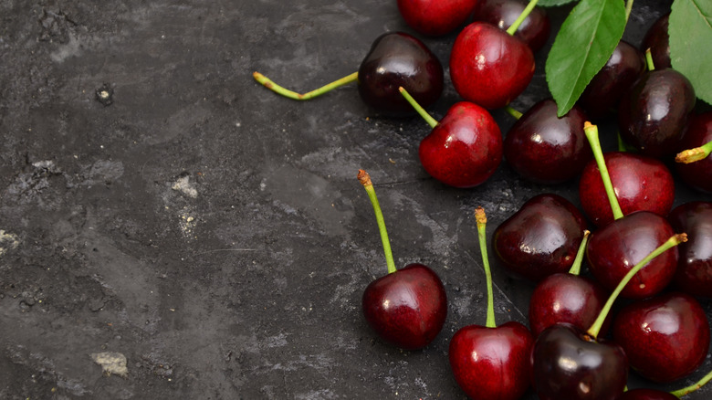 Fresh ripe cherries on a black table