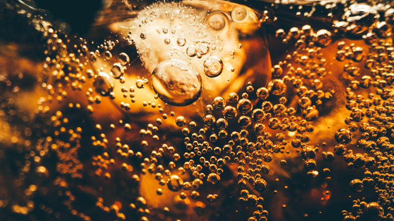 close up of cola soda in a glass with ice
